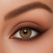 Close up of a brown eye with a softly smudged winged eyeliner in a soft milk chocolate brown color