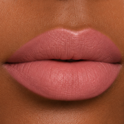 close-up lip image of a woman with medium-dark skin tone wearing Runway Rogue Velvet Glam long wear liquid lipstick in the shade Photogenic, a soft terracotta with a hint of spice 