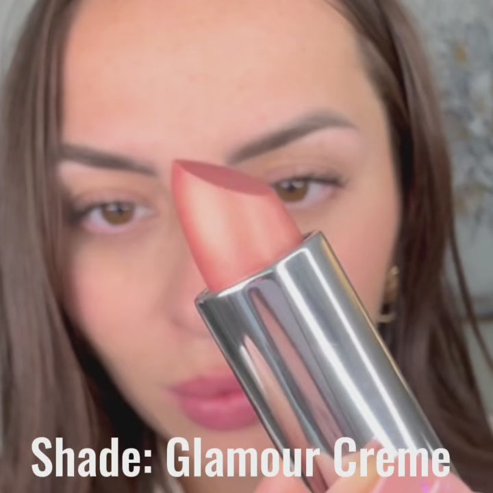Runway Rogue Glamour Crème Satin Shimmer Lipstick being applied for a soft, frosted peach-gold glow.
