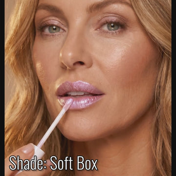 Woman applying Runway Rogue long wear liquid lipstick in the shade 'Soft Box'