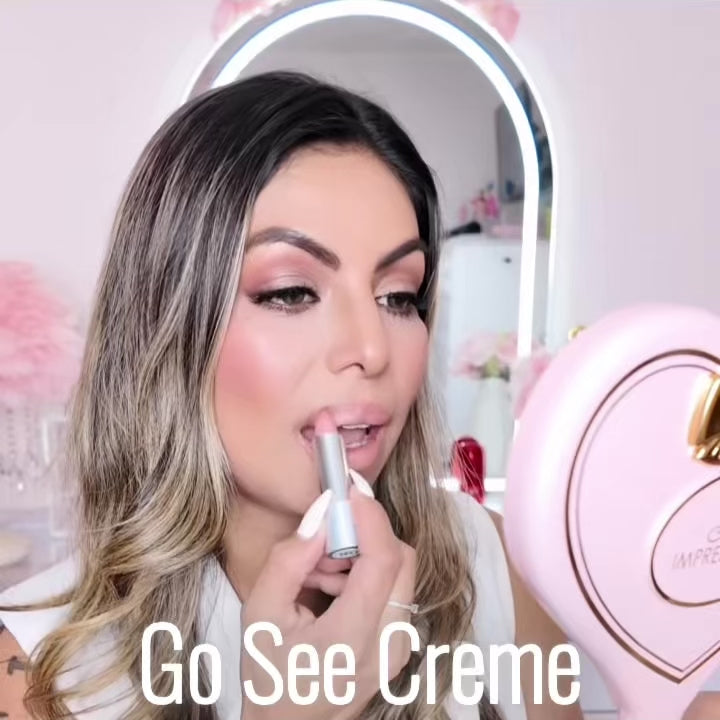 Video of a woman applying Runway Rogue Satin Shimmer Crème Lipstick in Go See Crème, a frosted pink with gold shimmer shade