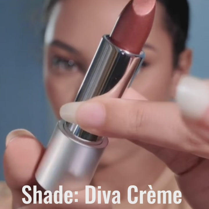 Close-up video of a woman gliding on Runway Rogue Satin Shimmer lipstick in Diva Crème for a soft shimmer finish.