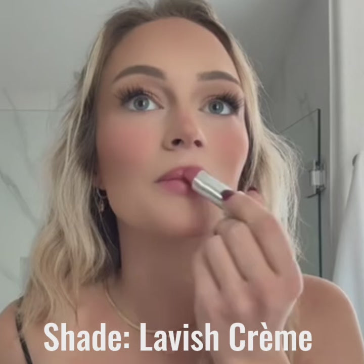 close-up of woman applying Satin Shimmer lipstick in 'Lavish Creme' showcasing the gorgeous soft shimmer rosy blush pink shade.