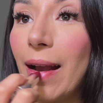 Video of a woman applying Runway Rogue Satin Shimmer Crème Lipstick in Mahvelous Crème, a luminous muted raspberry shade with pink and gold shimmer